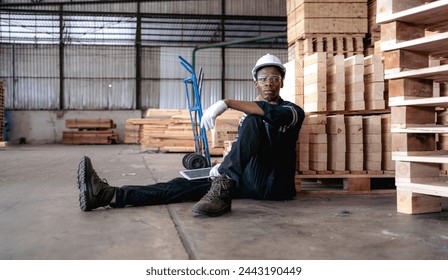 Multiracial engineer, worker sitting resting on floor feel tired from overworked in factory. Young adult technician feel weak, stress, exhausted, worried, frustrated, unhappy, hopeless, or headache
