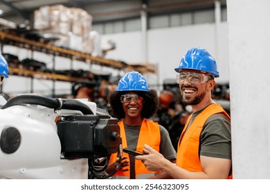 Multiracial engineers program a robotic arm with a smartphone in a high tech factory, showing innovation and teamwork in modern manufacturing - Powered by Shutterstock