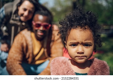 Multiracial Family Concept. Black Father And White Mother Playing With Their Daughter In The Park And Spending The Day Together. Focus On A Baby Girl.