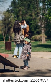 Multiracial Family Concept. Black Father And White Mother Playing With Their Daughter In The Park And Spending The Day Together.