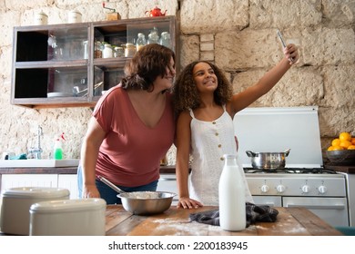 Multiracial family taking a selfie in the kitchen of their home - Shutterstock ID 2200183945