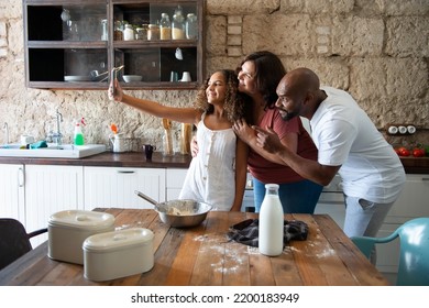 Multiracial family taking a selfie in the kitchen of their home - Shutterstock ID 2200183949