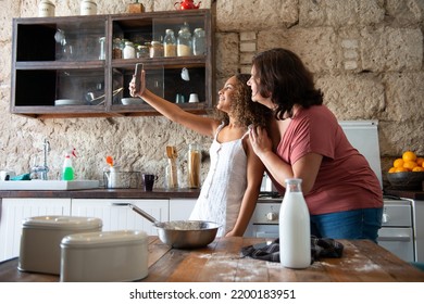 Multiracial family taking a selfie in the kitchen of their home - Shutterstock ID 2200183951