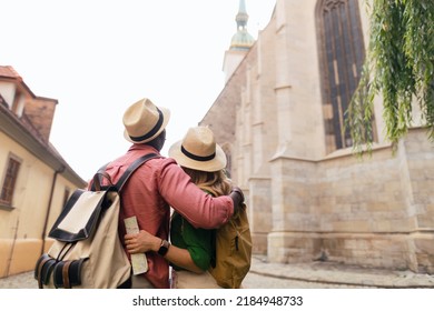 Multiracial Family Travel Together In Old City Centre, Looking At Map.