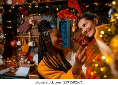 Multiracial female Women decorating Christmas tree - Powered by Shutterstock