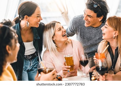 Multiracial friends celebrating summer party drinking fancy cocktail and red wine-Young group of people enjoying happy hour at winery terrace- Millennial guys having fun together-Youth Culture - Powered by Shutterstock