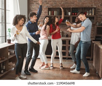 Multiracial Friends Dancing And Drinking Wine At Birthday Party At Home