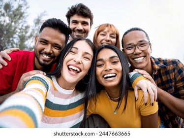 Multiracial friends group having fun taking selfie - Happy people hugging and posing for photo - Human resources concept - Powered by Shutterstock