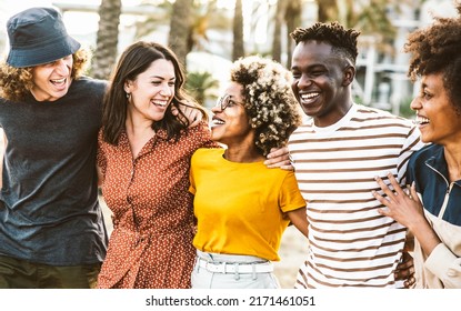 Multiracial friends having fun hanging outside together - Happy group of young people enjoying day out walking on city street - Friendship concept with guys and girls laughing on summer holidays  - Shutterstock ID 2171461051