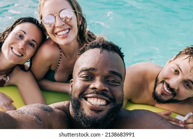 Multiracial Friends At Pool Party Having Fun Taking A Selfie During Summer Vacation - Focus On African Man Face