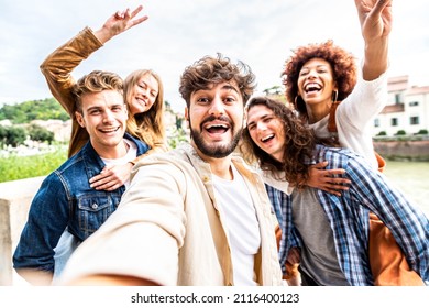 Multiracial friends taking selfie pic outside - Group of young people celebrating together looking at camera - Guys and girls having fun hanging out on sunny day - Friendship and happy lifestyle - Powered by Shutterstock