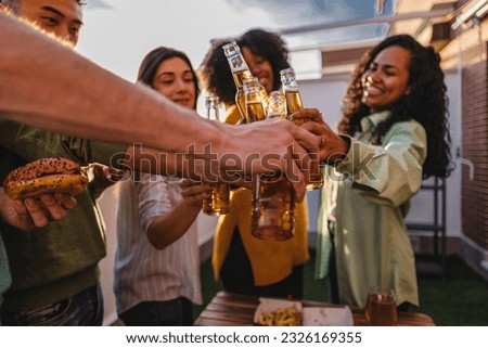 Multiracial friends toasting beer glasses at brewery pub garden - Happy young people enjoying happy hour sitting at restaurant bar - Millennials celebrating party