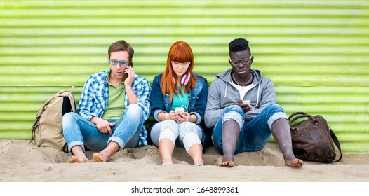 Multiracial friends using mobile smart phone at beach on relax moment - Young bored people addicted by smartphone - Technology concept with always connected millennials - Vivid green filter