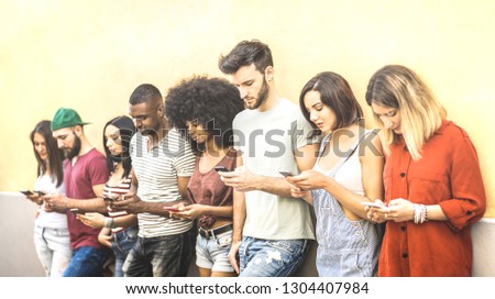 Multiracial friends using mobile smartphone at university coampus - Millenial people addicted by smart phones - Tech concept with always connected millennials on social networks - Bright warm filter