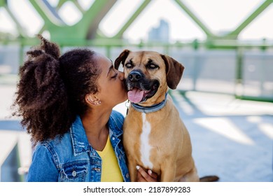 Multiracial Girl Sitting And Resting With Her Dog Outside In The Bridge, , Spending Leisure Time Together. Concept Of Relationship Between Dog And Teenager, Everyday Life With Pet.