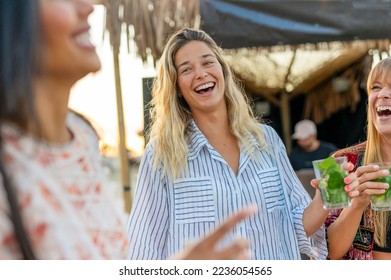 Multiracial girls having fun at chiringuito on the beach while drinking mojito -Confident blod lady  laughing at beach dance  - Shutterstock ID 2236054565