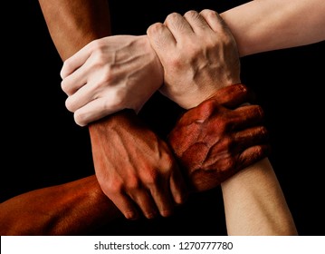 Multiracial Group With Black African American Caucasian And Asian Hands Holding Each Other Wrist In Tolerance Unity Love And Anti Racism Concept Isolated On Black Background