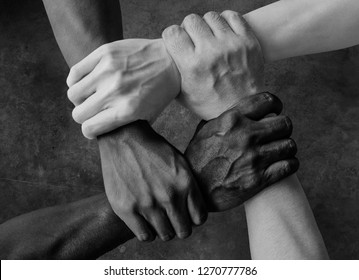 Multiracial Group With Black African American Caucasian And Asian Hands Holding Each Other Wrist In Tolerance Unity Love And Anti Racism Concept In Black And White Isolated Background