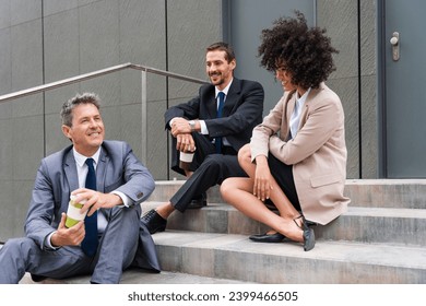 Multiracial group of business people bonding outdoors - International business corporate team wearing elegant suit meeting in a business park