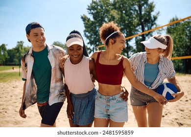 Multiracial group of cheerful friends enjoying in volleyball on the beach. - Powered by Shutterstock