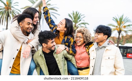 Multiracial Group Of Friends Bonding Outside - Happy Young People Walking Down The Street Laughing And Having Fun - Adult Students Hangout Together In The City Center - Friendship Lifestyle Concept