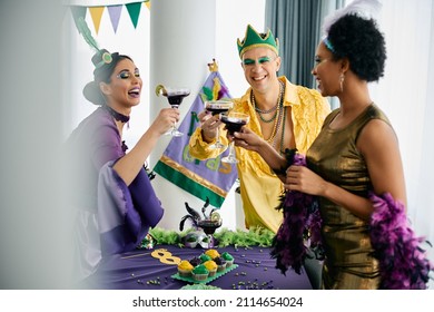 Multiracial Group Of Friends Celebrating Mardi Gras And Toasting With Drinks At Home Party. 