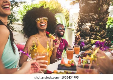 Multiracial group of friends having fun at backyard home party - Young people laughing together drinking cocktails at bar restaurant - Focus on black woman - Shutterstock ID 1935434995