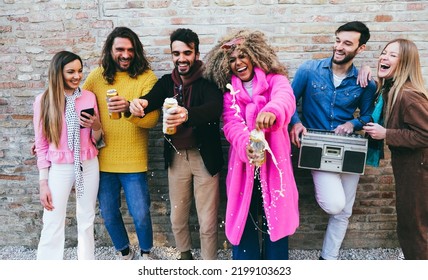 Multiracial Group Of Friends Having Fun Opening Beer Cans While Listening Playlist Music In Boombox Stereo Outdoor - Focus On African Girl Face