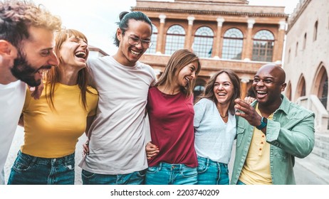 Multiracial Group Of Friends Having Fun Walking On City Street - Happy Young People Hanging Outside Together On Weekend Day  - Friendship Concept With Guys And Girls Laughing Out Loud 