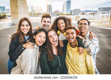 Multiracial group of friends taking selfie picture outdoors - Millennial people having fun on city street - International students smiling together at camera - Youth culture and community concept - Powered by Shutterstock