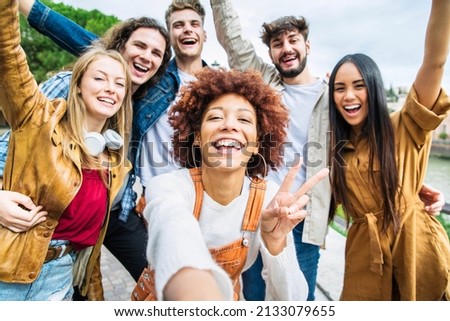 Multiracial group of friends taking selfie pic outside - Happy different young people having fun walking in city center - Youth lifestyle concept with guys and girls enjoying day out together 