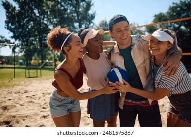 Multiracial group of happy friends playing beach volleyball.  - Powered by Shutterstock