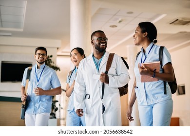 Multiracial Group Of Medical Students Walking In A Hallway At Medical University. Focus Is On African American Male Student.