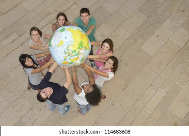 Multiracial Group Of People Holding  The Earth Globe Showing Europe