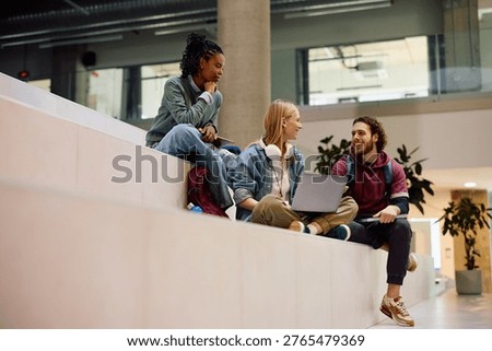Multiracial group of students using laptop while e-learning at the university. Copy space. 