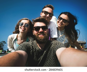 Multiracial Group Of Young Hipster Friends Make Selfie Photo With Smartphone Camera In Phuket While Traveling Across Thailand On Vacation. Funny Outdoor Activity Of Young Students Away From Home.