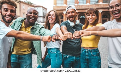 Multiracial Group Of Young People Making Fist Bump As Symbol Of Unity, Community And Solidarity - Happy Friends Portrait Standing Outdoors - Teamwork Join Hands And Support Together