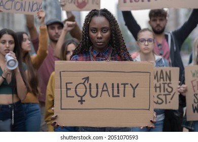 Multiracial group of young people walking together protesting for equality against racism  - Powered by Shutterstock