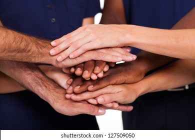 multiracial hands together to form teamwork
