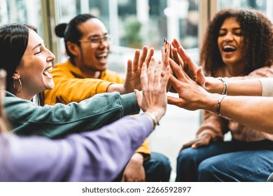 Multiracial happy young people stacking hands-Group of diverse friends having fun unity together indoors at table of community-Human resources Concept Creative and Relationship Youth Culture - Shutterstock ID 2266592897