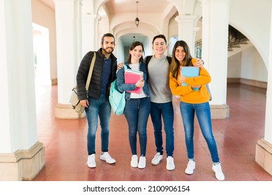 Multiracial latin and caucasian students smiling and making eye contact while getting ready for class at university - Shutterstock ID 2100906154