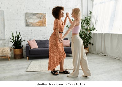 A multiracial lesbian couple dances joyfully in their modern apartment, their laughter echoing in the bright space. - Powered by Shutterstock