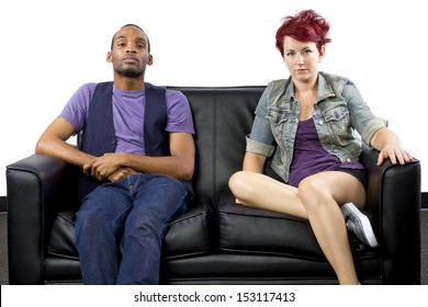 Multi-racial Male And Female Roommates Sharing A Couch