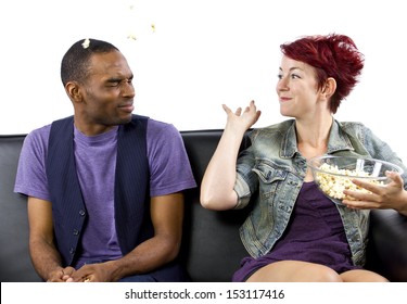 Multi-racial Male And Female Roommates Sharing A Couch