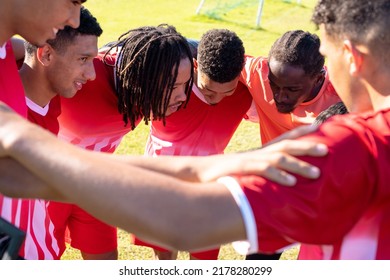 Multiracial male soccer players with arms around huddling and discussing in playground during match. Motivation, meeting, unaltered, soccer, sport, teamwork, togetherness and competition concept. - Powered by Shutterstock