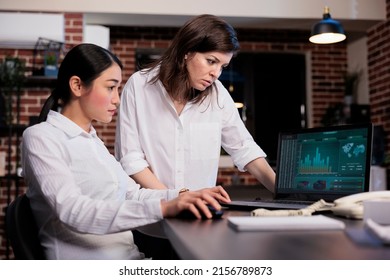 Multiracial Marketing Company Employees In Office Workspace Analyzing Financial Charts And Graphs. Executive Board Members Reviewing Wrongly Issued Accounting Data On Laptop Screen.