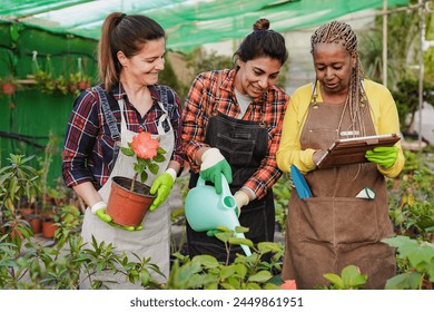 Multiracial mature women working inside garden center using digital tablet - Harvest and greenhouse concept - Powered by Shutterstock