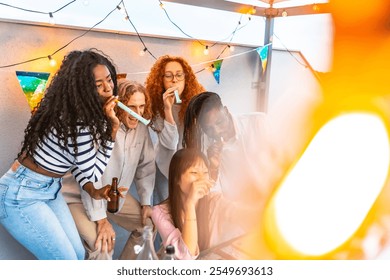 Multiracial millennial friends blowing streamers while taking selfie during birthday party at rooftop - Powered by Shutterstock