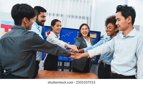 Multiracial office worker's hand stack shows solidarity, teamwork and trust in diverse community. Businesspeople unite for business success through synergy and collaboration by hand stacking. Concord