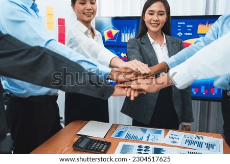 Multiracial office worker's hand stack shows solidarity, teamwork and trust in diverse community. Businesspeople unite for business success through synergy and collaboration by hand stacking. Concord
